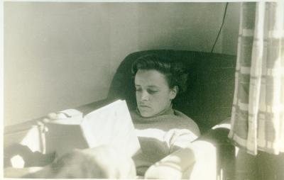 Student reading, probably in the South Lodge (men's dormitories) of the Lake Eden campus