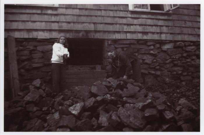 Verna Raattama Schauffler or Dorothy Raattama Bergman and unidentified student hauling coal at Lake Eden campus