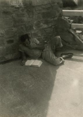 Harry Holl reading outside the Studies Building