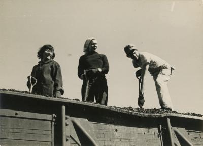 Vera Baker Williams, Nancy Miller Archer, and Gregory Masurovsky shoveling coal