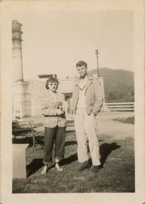 Erris Burnett and Jay Watt outside of the Studies Building with puppy