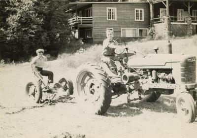 Bill Treichler and Nancy Miller Archer mowing the grass