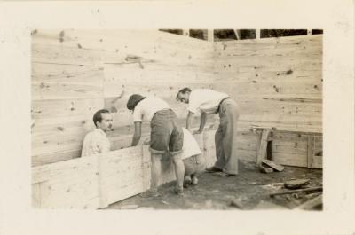 Richard "Dick" Carpetner, Lawrence "Larry" Kocher, and Martha "Marty" Elliot Hunt with others pouring concrete