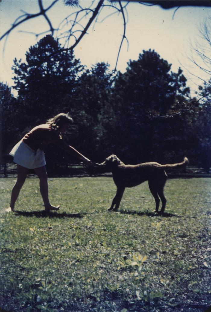 Barbara Anderson playing with a dog