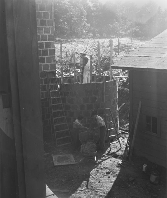 Pearson Mundy, student Nancy West, and two other students building the silo at the BMC College Farm